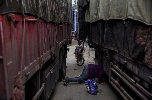 China senior looking for veggies fallen off truck (Getty) May 31 2015