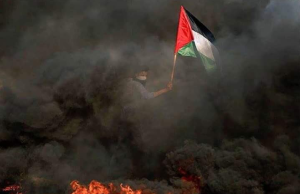 Palestinian flag amidst burning tires (Aug 1 2017