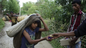 Refugee fromRohingya being offered food by Bangladeshi volunteer  (EPA) Sept 14 2017